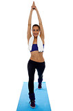 Fit woman doing stretching exercise