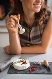 Closeup on happy young woman eating camembert