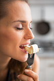 Young woman eating camembert