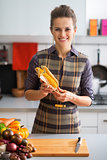 Portrait of happy young housewife with corn