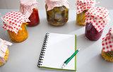 Notepad among jars of pickled vegetables