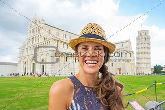 Portrait of happy young woman on piazza dei miracoli, pisa, tusc