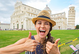 Portrait of happy young woman showing thumbs up on piazza dei mi