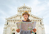 Happy young woman with map in front of duomo di pisa, pisa, tusc