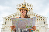 Portrait of smiling young woman with map in front of duomo di pi