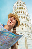 Young woman with map in front of leaning tower of pisa, tuscany,
