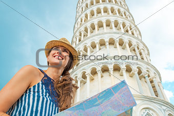 Happy young woman with map in front of leaning tower of pisa, tu