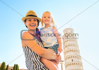 Portrait of mother and baby girl in front of leaning tower of pi