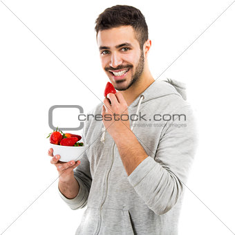 Happy young eating a strawberry
