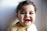 Charming 8 months old baby boy looking cheerful and laugh