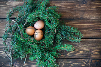 Easter egg in the nest on rustic wooden background