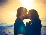 Young couple kissing in the sunlight