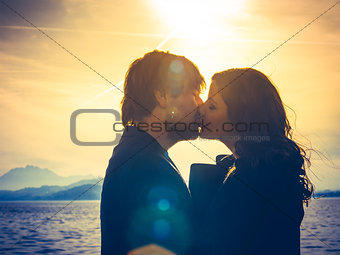 Young couple kissing in the sunlight