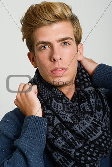 Portrait of good looking blonde man wearing a scarf