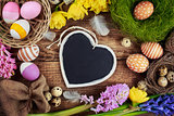  Chalk board in the shape of hearts and Easter decorations 