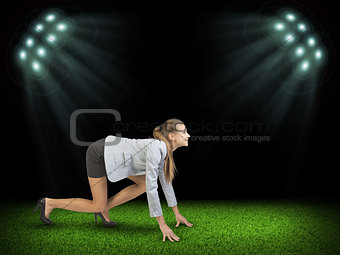 Woman begins to start. Green grass and black sky with rays of searchlights