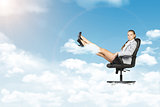 Woman sitting in chair. Background of clouds, sky, sun