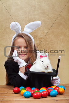Young magician after successfully conjuring an easter rabbit