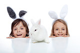 Kids with their white rabbit pet