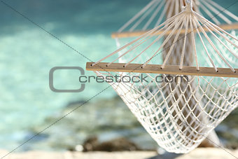 Travel concept with a hammock in a tropical beach