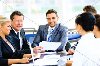 Portrait of young handsome businessman in office