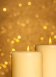 candles with flame on golden bokeh