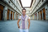 Portrait of smiling young woman near uffizi gallery in florence,