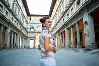 Young woman standing near uffizi gallery in florence, italy