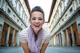 Portrait of happy young woman near uffizi gallery in florence, i