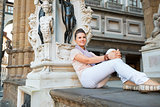 Young woman sitting in loggia dei lanzi in florence, italy