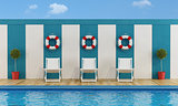 Pool with white deckchairs