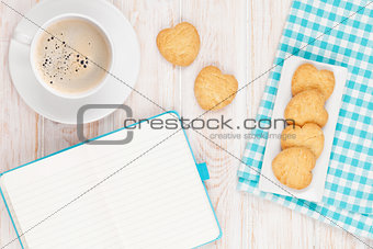 Coffee, heart shaped cookies and notepad