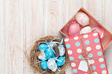 Easter with blue and white eggs in nest and gift box