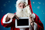 Portrait Santa Claus pointing on slate