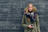 Woman in Winter Outfit in Front Old Gray Wall