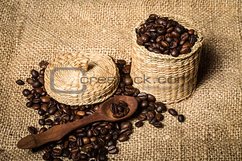 pile of fresh and bio aromatic coffee beans and spoon and jar
