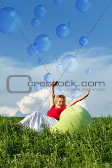 Bubbling vitality - woman on spring grassland
