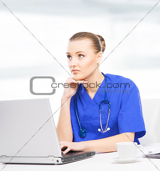 Young, professional and cheerful female doctor working in office