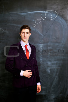 Businessman witn chalkboard  on background
