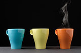 Three colorful mug with steam