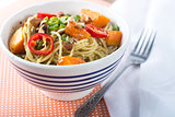 Bowl of pesto pasta with fresh vegetables