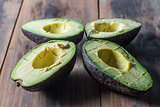 Slives of ripe avocado on rustic surface