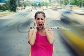 Portrait business woman screaming at street car traffic 