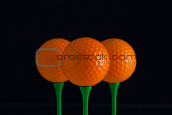 Golf balls and green wooden tees 