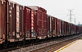 Red freight train box cars in perspective