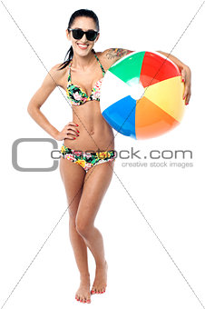 Bikini woman holding colorful beach ball