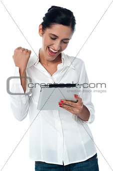 Excited pretty woman using tablet pc