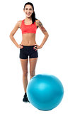 Young woman in gym wear with exercise ball