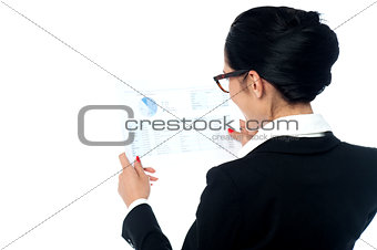 Businesswoman reviewing annual report