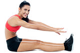 Female gym instructor stretching her body